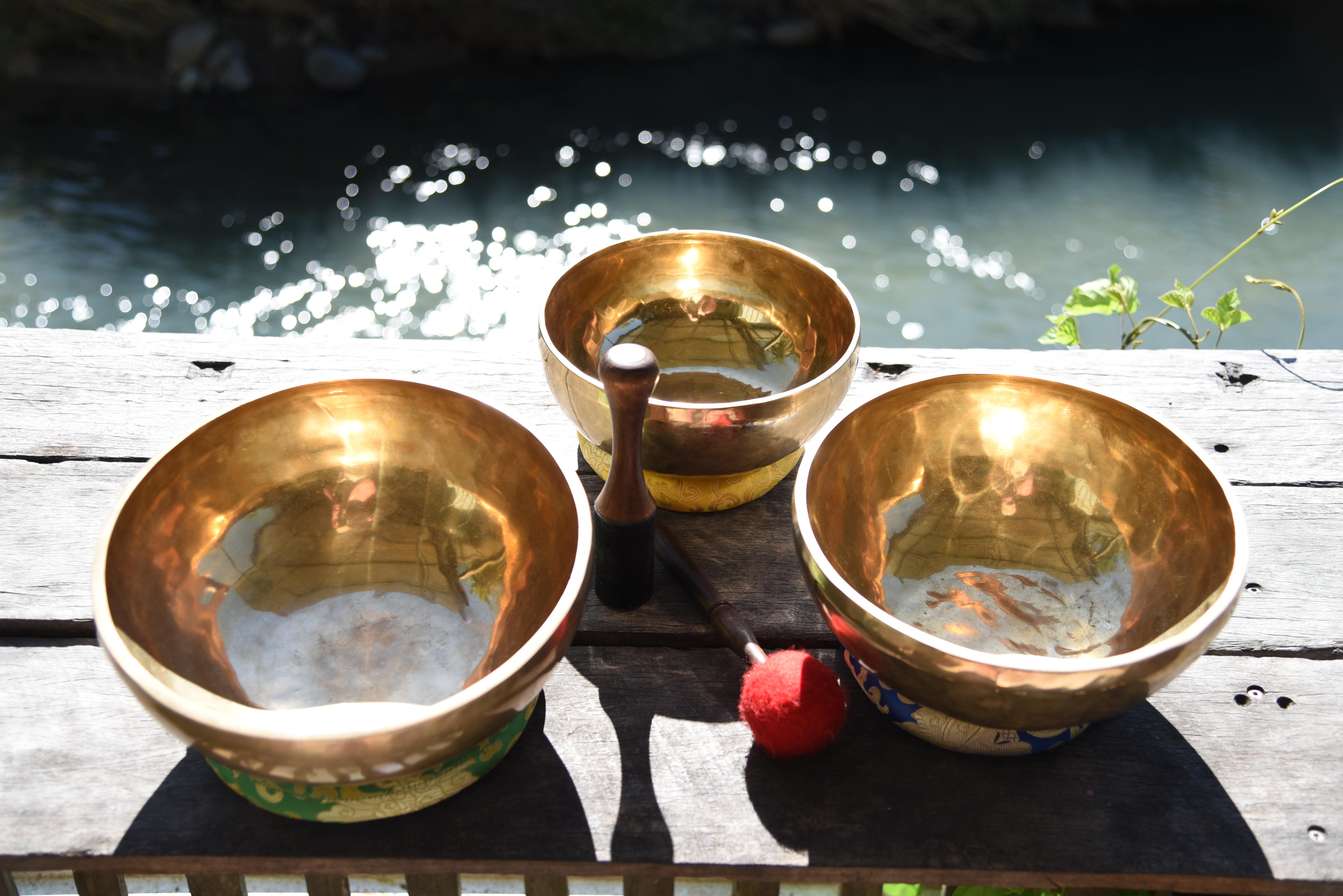Sacred bowls in serene waterside meditation setting